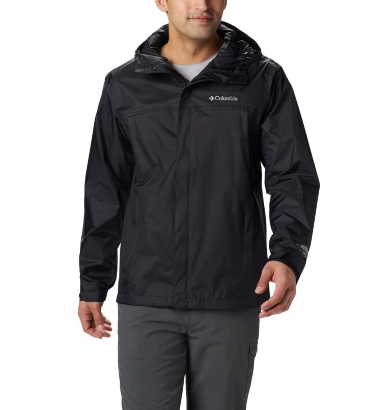 Man wearing a black Columbia rain jacket with a hood and gray pants