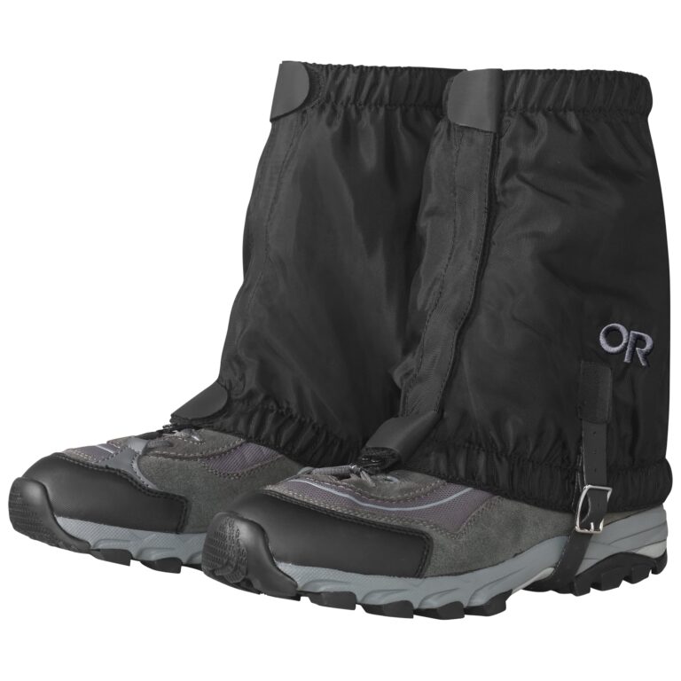 Black hiking gaiters over gray hiking boots, isolated on white background